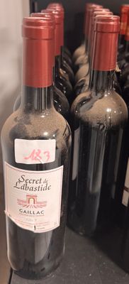 several bottles of wine are lined up on a shelf in a store