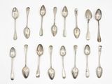 many spoons and spoon spoons laid out on a white surface