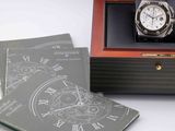 a watch in a box with a book on the table