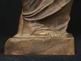 bronze statue of a woman holding a baby in her arms