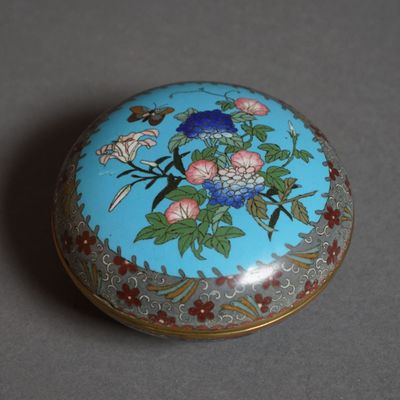 an image of a blue and gold box with flowers on it