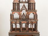 a wooden model of a castle sitting on a table