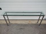 a glass table with a metal frame on it
