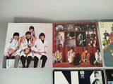 the beatles album covers are displayed on a shelf in a room