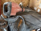 a red and black blow dryer sitting on top of a pile of boxes