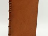 a brown book with a leather cover on a white background
