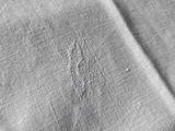 close up of a piece of white linen with holes in it