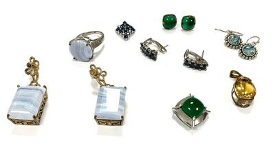 many different types of jewelry displayed on a white surface