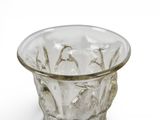 a clear glass vase with a gold rim on a white surface