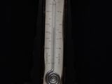 a black clock with a thermometer on it