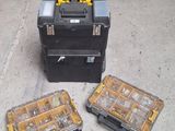 two tool boxes sitting on the ground next to each other