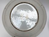 an overhead view of a white ceiling light with a round window