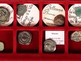 many coins in a red box with writing on them