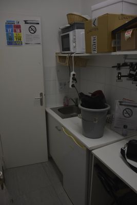 a small kitchen with a sink and a microwave in it