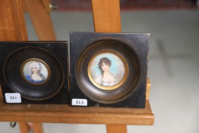 two framed pictures of a woman and a man on a easel