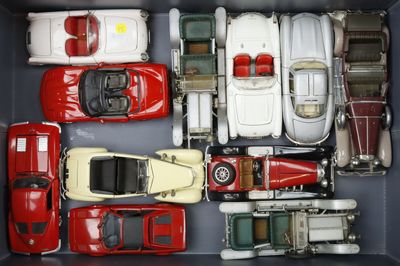 a lot of toy cars in a box on the table