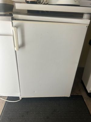 a white stove top oven sitting in the corner of a kitchen