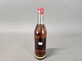 a small bottle of syrup sitting on a table