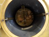 a close up of a clock that is in the middle of a hole