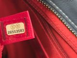 an image of a close up of a red purse with a tag on it