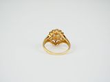 an image of a gold ring with a flower design on it