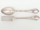 two silver spoons and a fork on a white surface