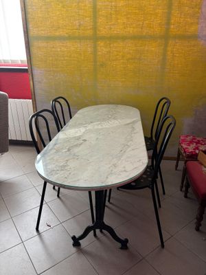 a table and chairs in a room with a yellow wall