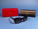 an image of a pair of sunglasses and a case on a blue surface