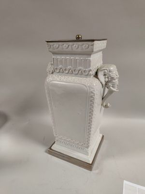 a white vase that is sitting on a table