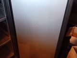 a refrigerator that is sitting in the corner of a room
