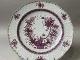 purple and white plate with a floral design on the rim