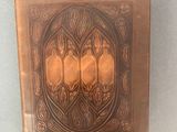 a brown book with an intricate design on it