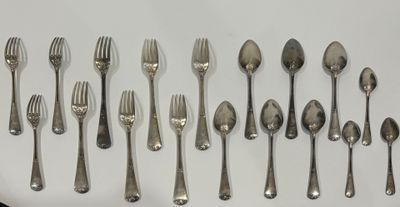 a lot of silver spoons and forks on the table