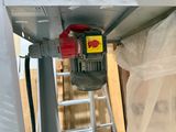 a picture of a ladder with a red and yellow device attached to it