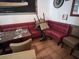 tables and chairs in a restaurant with a chalkboard on the wall