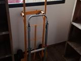 a hand truck that is sitting in front of a window