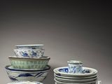 many bowls and cups that are sitting on a table