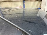 a glass table that has been broken in the middle of a parking lot