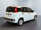 the small white car is parked in a large room