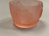 peach colored glass bowl with a design of flowers and leaves