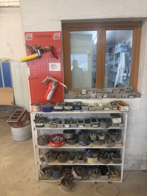 a picture of a shoe rack with many pairs of shoes on it