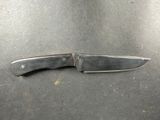 a knife that is laying on top of a table