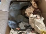 a dog that is laying in a box full of newspaper