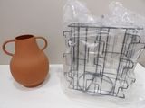 a brown vase and a brown vase on a white table