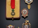 an assortment of medals and pins are displayed in a case