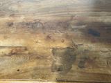 a close up of a wooden table with a brown stain on it