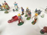 many figurines of people that are on a white surface