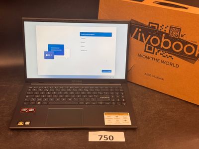 a laptop that is sitting on a table next to a box