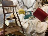 a small wooden chair sitting next to a chair on a table