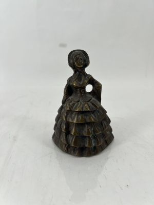 a small bronze figurine of a woman in a dress